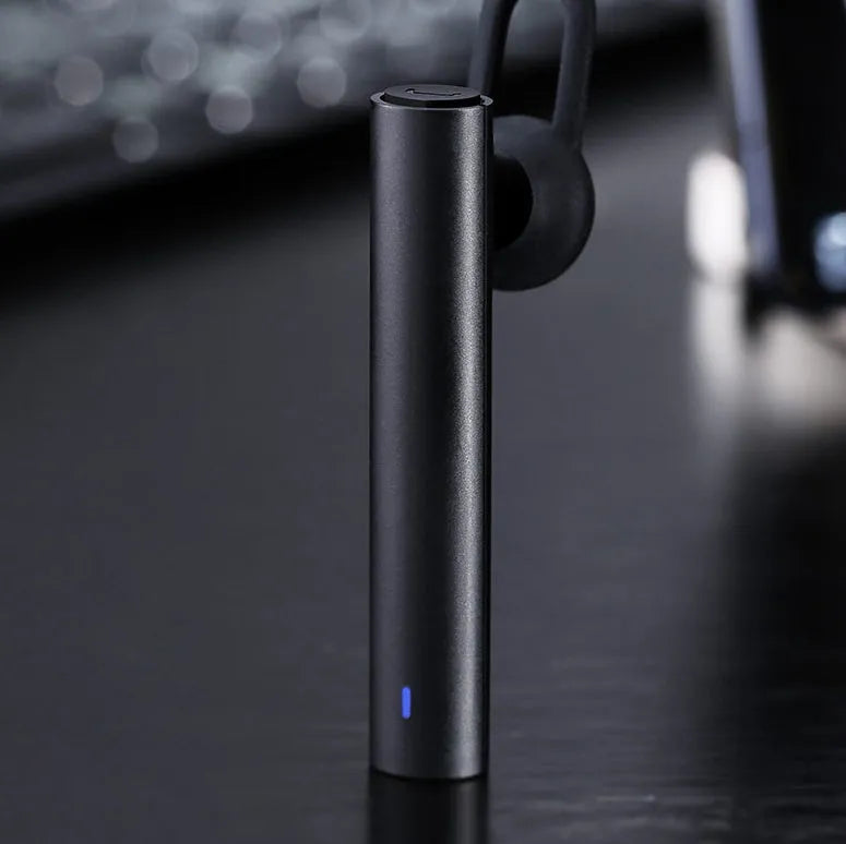 Compact wireless Bluetooth headset in black, measuring 5.6 cm x 1 cm x 0.8 cm, with earpiece and charging port visible