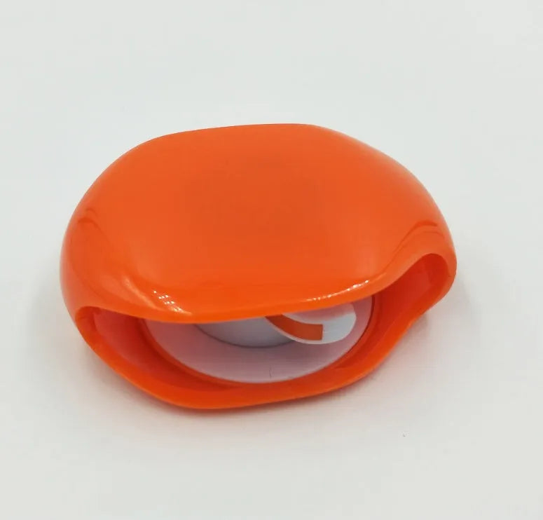 Automatic earphone cable winder retractor in multiple colours showing compact size