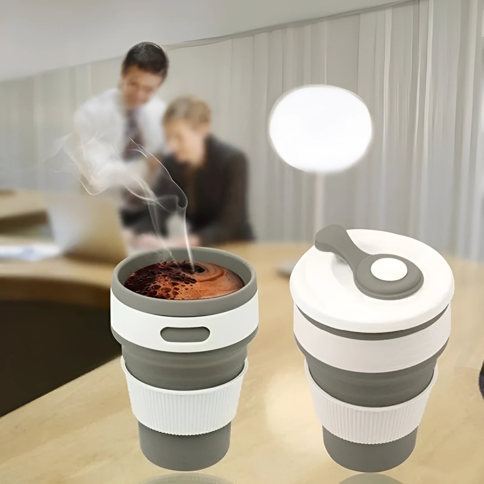 Collapsible silicone travel cup in grey, folded to 6 cm height, with anti-hot handle and leak-proof cover