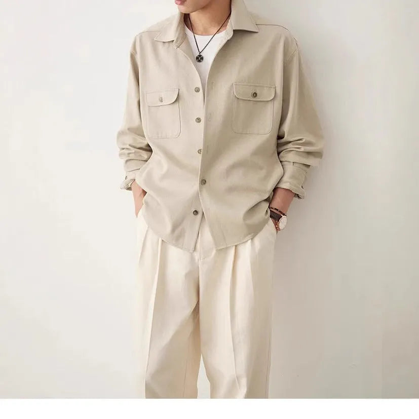 Men's light sand rice coloured cotton shirt with lapel collar and long sleeves laid flat.