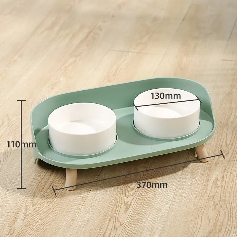Tilted double bowl pet feeder in green with separate compartments for food and water