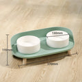 Tilted double bowl pet feeder in green with separate compartments for food and water