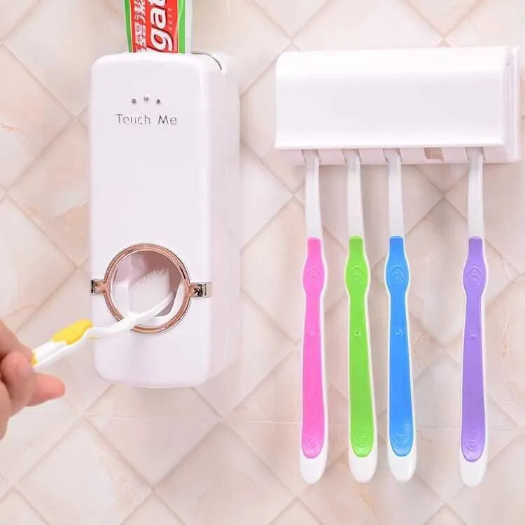White plastic and silicone bathroom accessories set with toothbrush holder and pump dispenser on a tiled wall