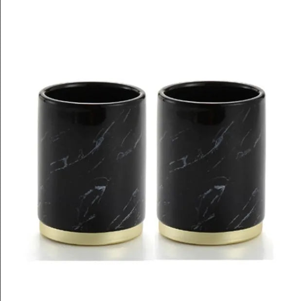 Four-piece ceramic bathroom set with bright glaze finish including bottle, cup, toothbrush holder, and soap dish