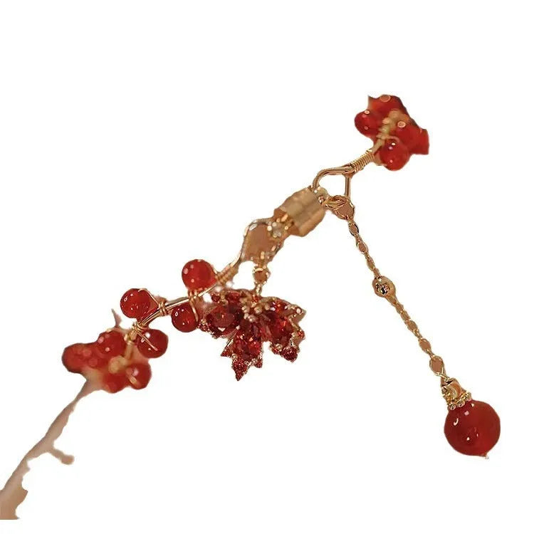 Red ginkgo leaf magnetic bracelet in alloy with electroplated finish on white background