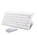 Black wireless keyboard and mouse set on wooden desk with USB receiver