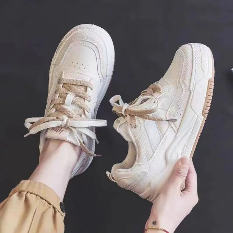 Beige and pink low-top sneaker with a height-increasing rubber sole on a white background