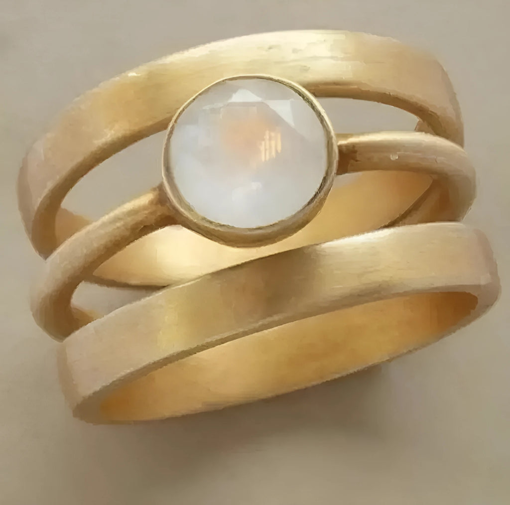 Gold-plated geometric ring with hollow micro-inlaid white chalcedony gemstone and line pattern design