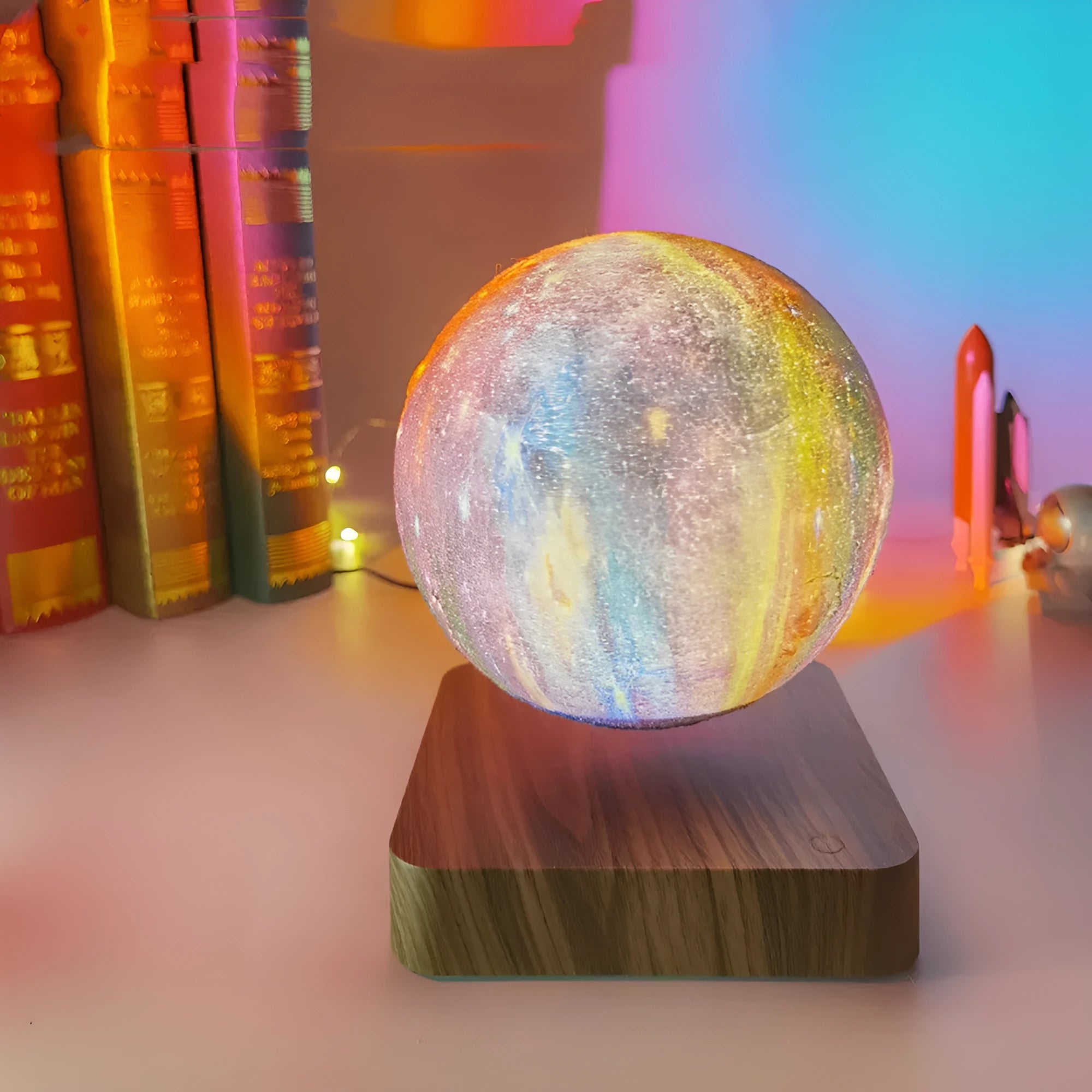 Magnetic levitation galaxy moon lamp floating above walnut-coloured base with starry light projection