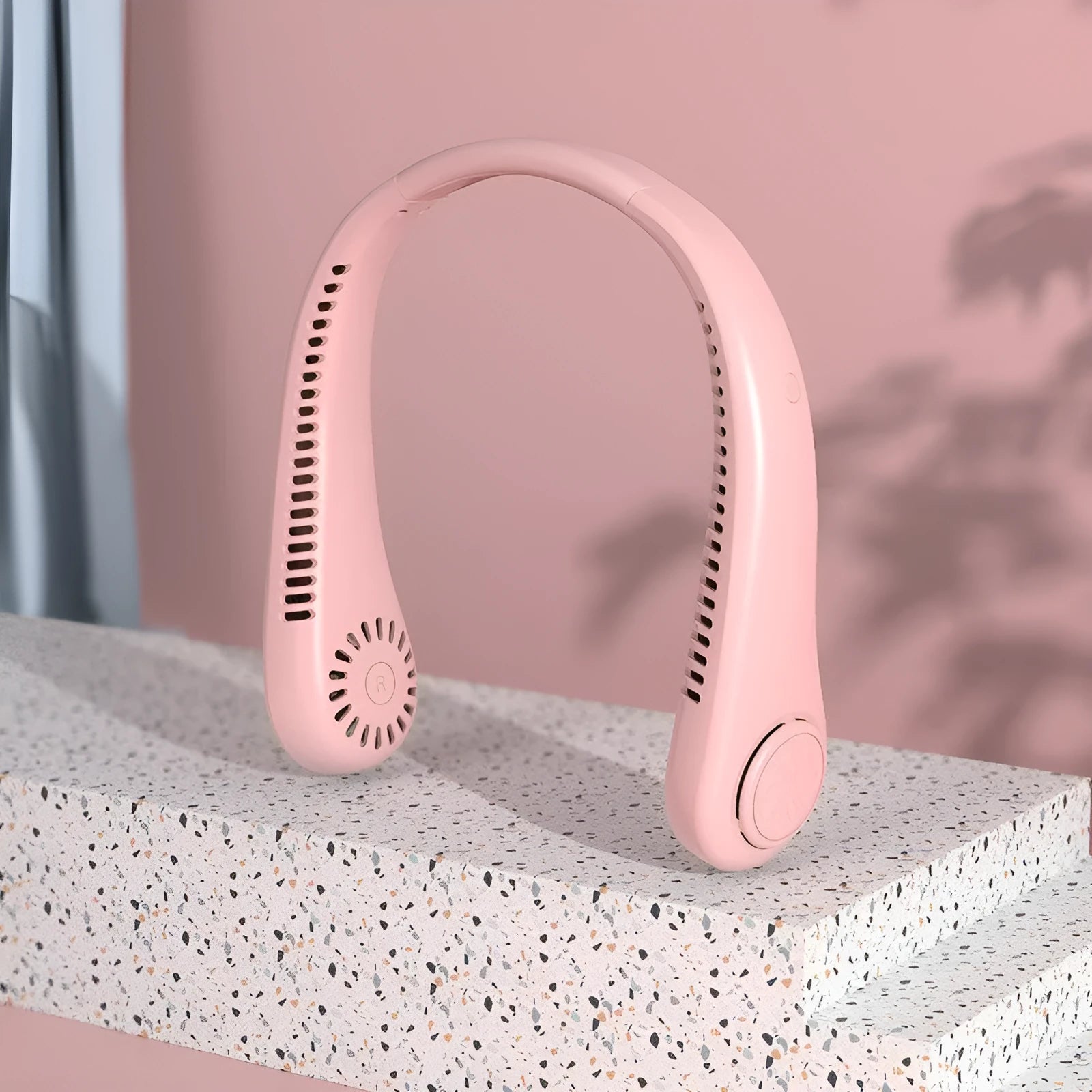Pink USB rechargeable bladeless neck fan with a flexible neckband, shown in a folded position.