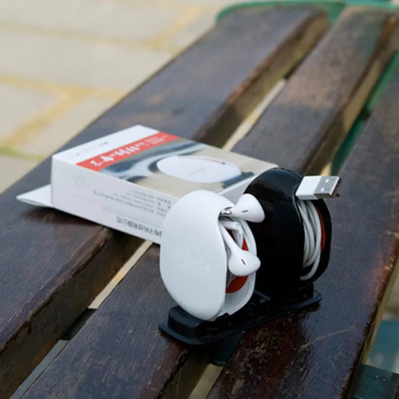 Automatic earphone cable winder retractor in multiple colours showing compact size