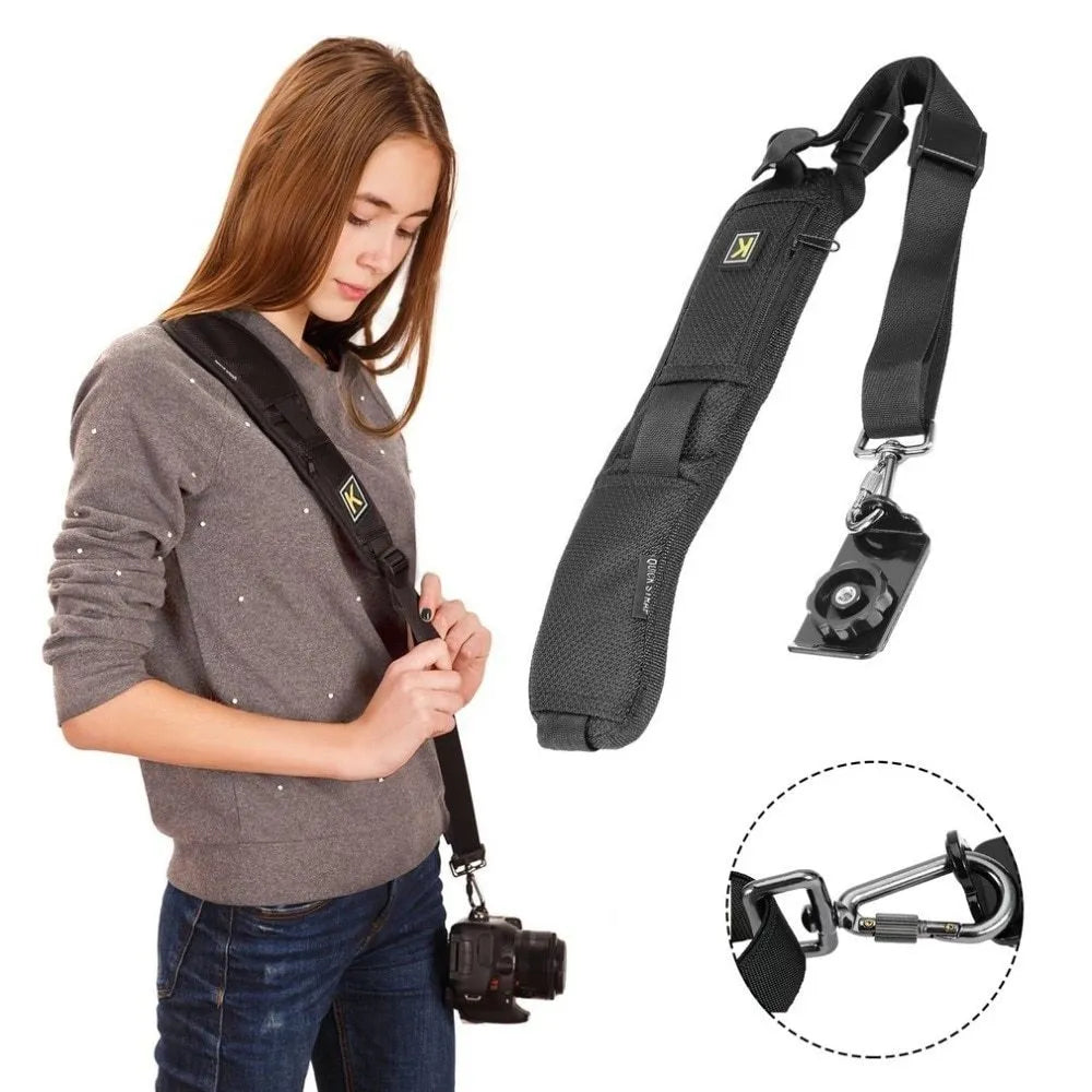 Black nylon DSLR sling strap with metal buckle and screw plate on table