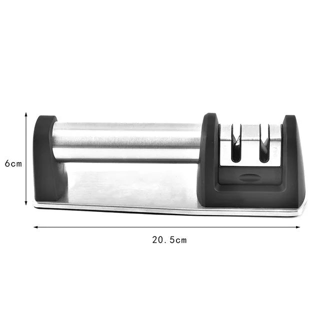New kitchen sharpener made of black ABS plastic on a surface, manual knife sharpening tool