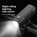 Black USB-rechargeable bicycle headlight mounted on bike handlebars with strap bracket.