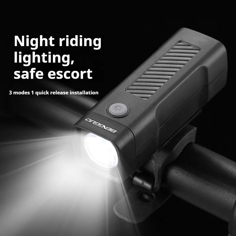 Black USB-rechargeable bicycle headlight mounted on bike handlebars with strap bracket.