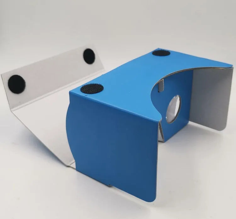 Pink and white cardboard VR headset for smartphones with adjustable straps and 3D lenses.