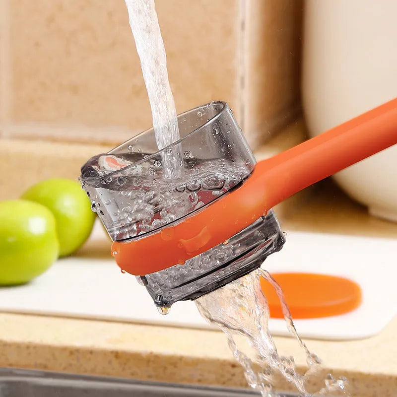 Kitchen multi-functional peeler with bucket storage in light green plastic on a clean countertop