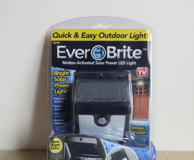 Set of four white solar-powered LED motion sensor lights for outdoor garden and security use.