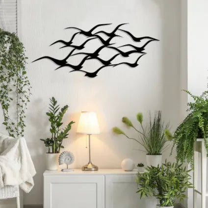 Metal flying bird wall decoration with seagull finish on a white wall