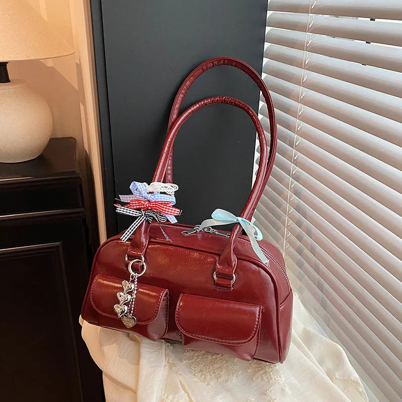 Brown PU leather women's retro pillow bag with double shoulder strap and flap closure.