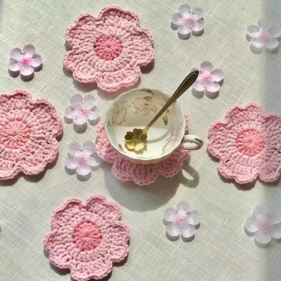 Hand-woven finished wool coaster on a wooden table surface