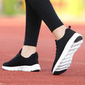 Women's black running shoes with a fly weave upper and wear-resistant outsole.