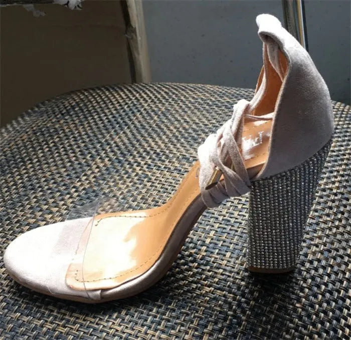 Women's black and gold pointed-toe high heels with plastic construction