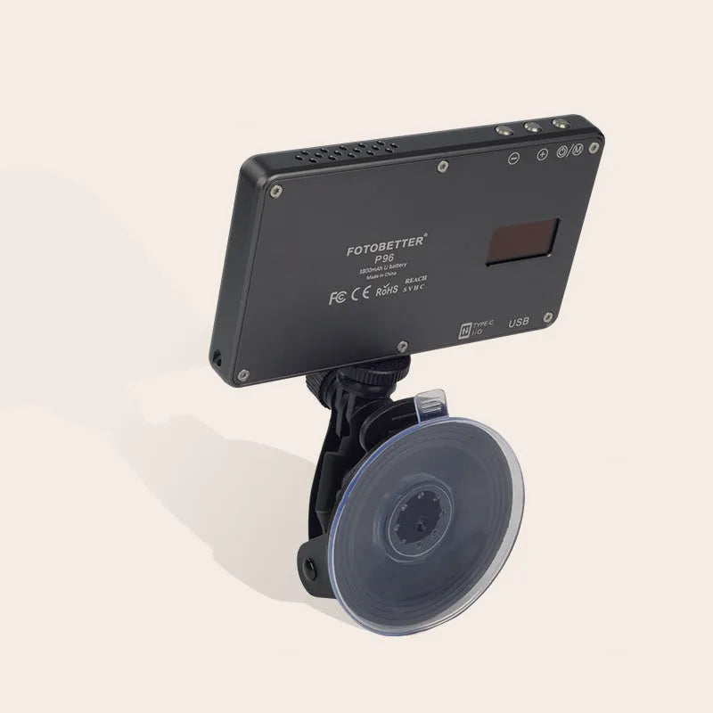 Black aluminium alloy portable LED ring light for laptop video conferencing on a desk.