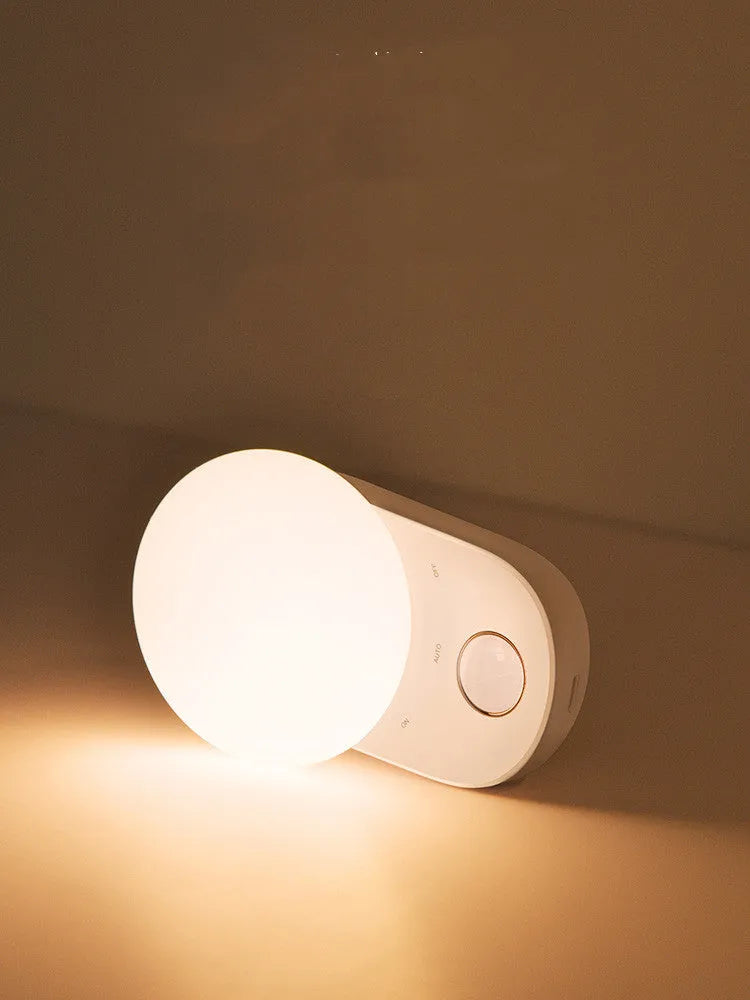 White rechargeable night light with motion sensor and LED illumination for bedside use