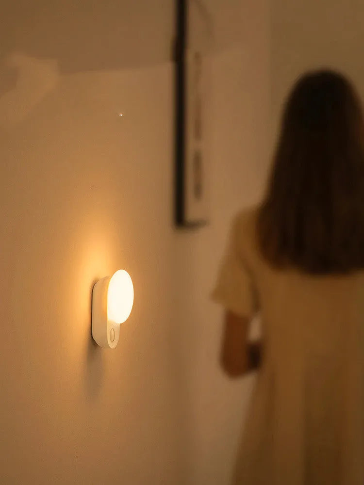 White rechargeable night light with motion sensor and LED illumination for bedside use