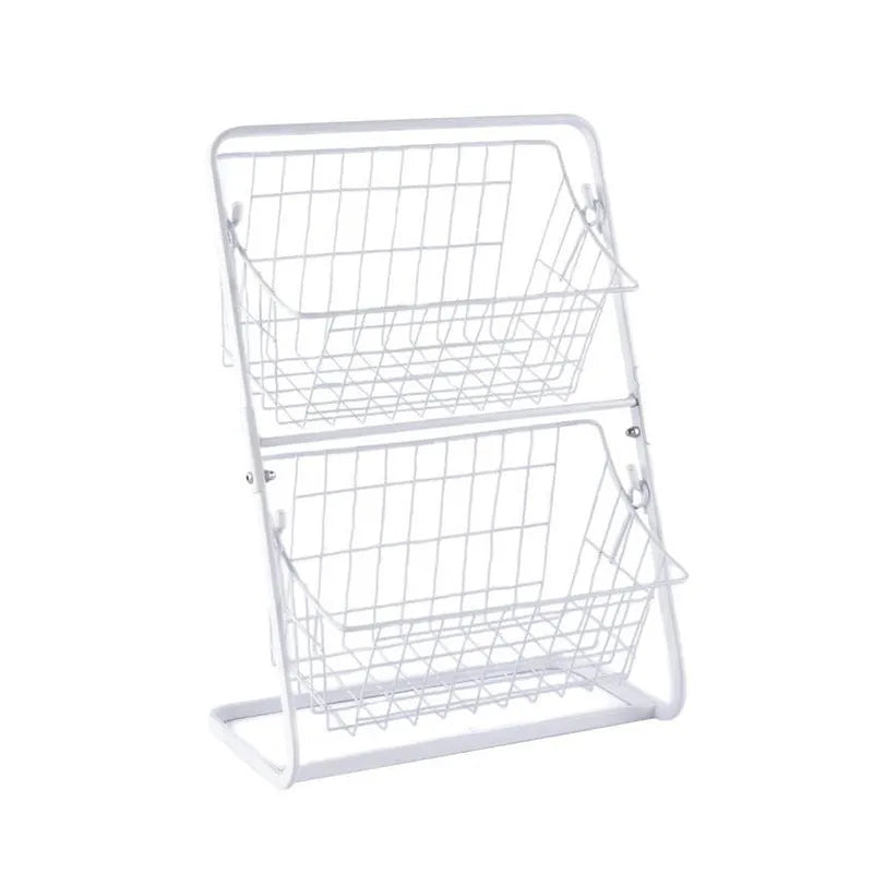 Black two-tier iron art kitchen storage rack with hollowed sides on countertop holding fruit and vegetables