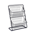 Black two-tier iron art kitchen storage rack with hollowed sides on countertop holding fruit and vegetables