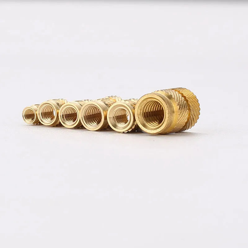 Brass M2 and M3 hot melt copper nuts with outer diameters 3.8mm 4.0mm and 4.2mm on a white background
