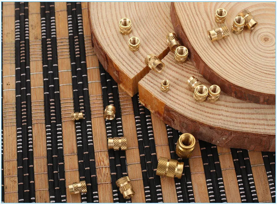 Brass M2 and M3 hot melt copper nuts with outer diameters 3.8mm 4.0mm and 4.2mm on a white background