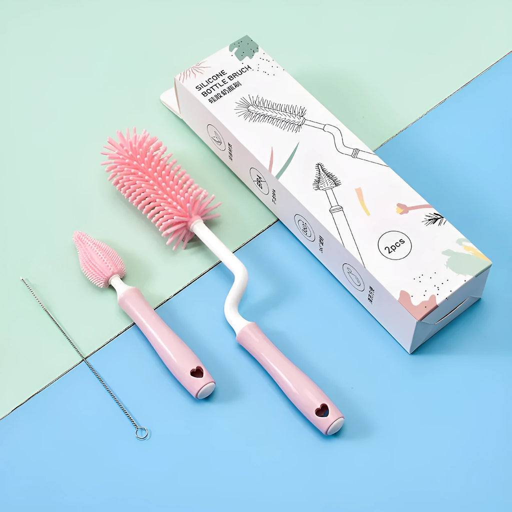 Three-piece silicone baby bottle brush set in pink, blue, and yellow with straw cleaning tool