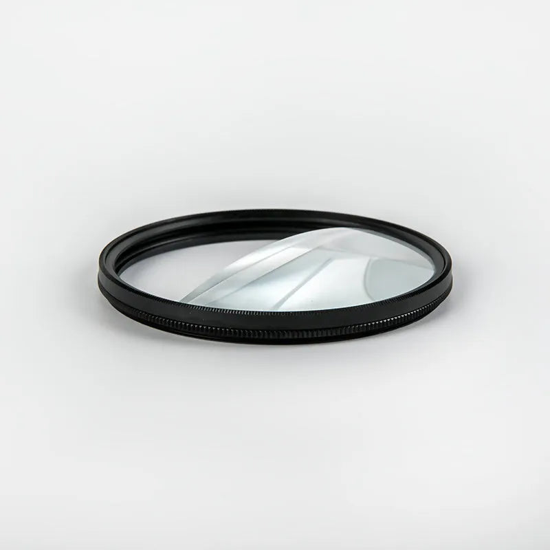 77mm half moon mirror camera filter for creative split-focus photography on a lens.
