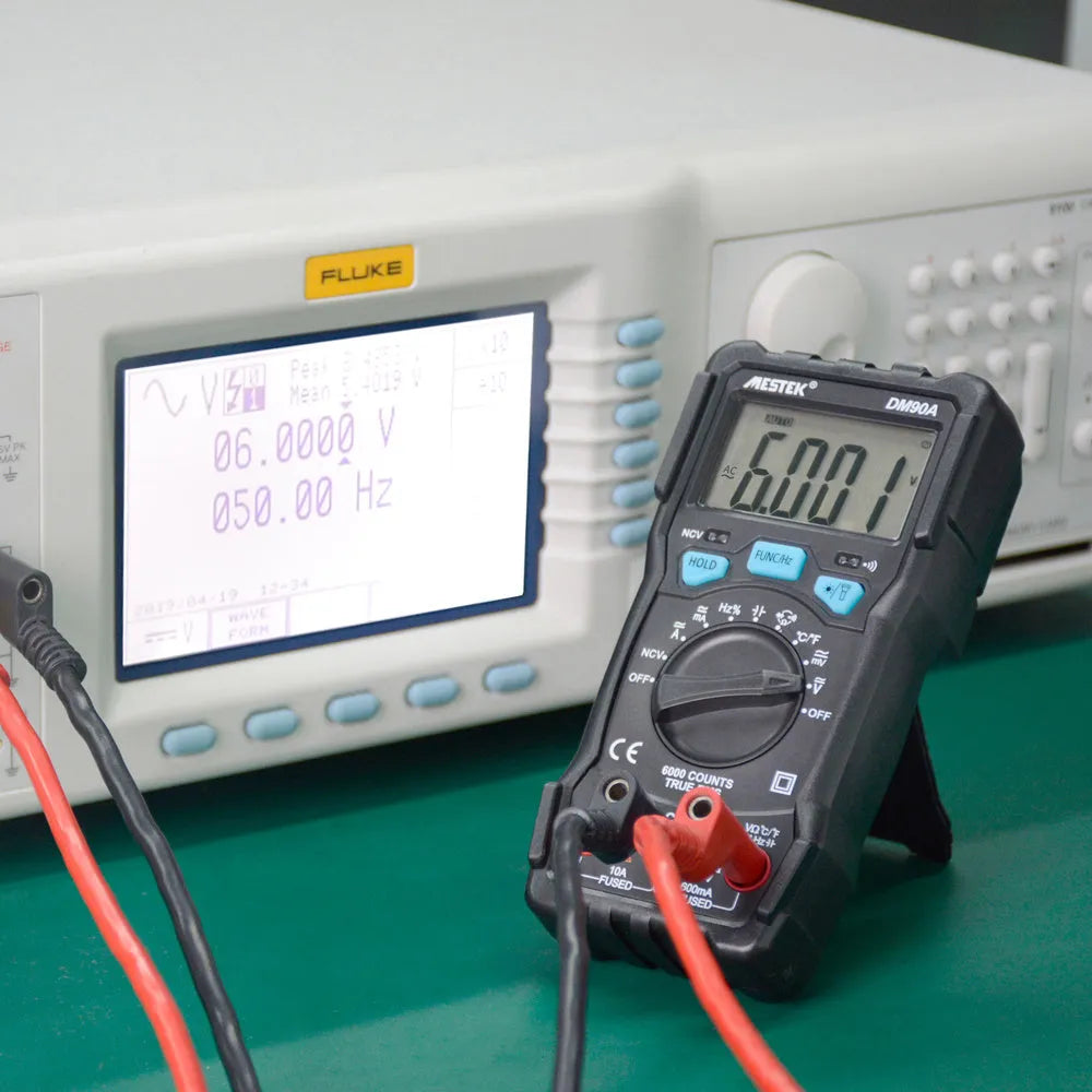DM90A digital multimeter with display showing readings, includes test leads for electrical and temperature measurement.