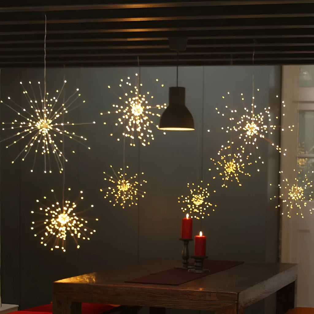 Solar-powered LED firework explosion light hanging outdoors with warm white meteor shower effect.