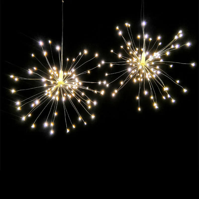 Solar-powered LED firework explosion light hanging outdoors with warm white meteor shower effect.