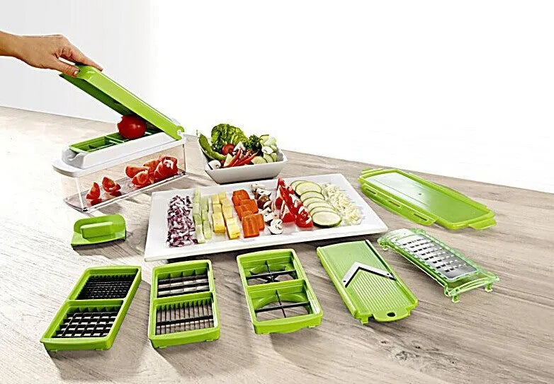 Green multifunctional vegetable chopper with handle, grater, and stainless steel blades on a chopping board