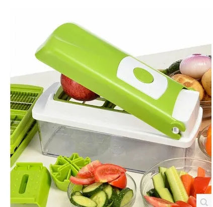 Green multifunctional vegetable chopper with handle, grater, and stainless steel blades on a chopping board
