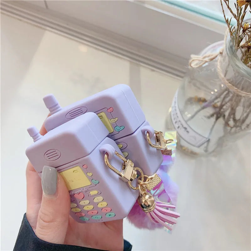 Purple silicone clamshell case for Apple AirPods Pro and AirPods 1 2 with a fur ball pendant.