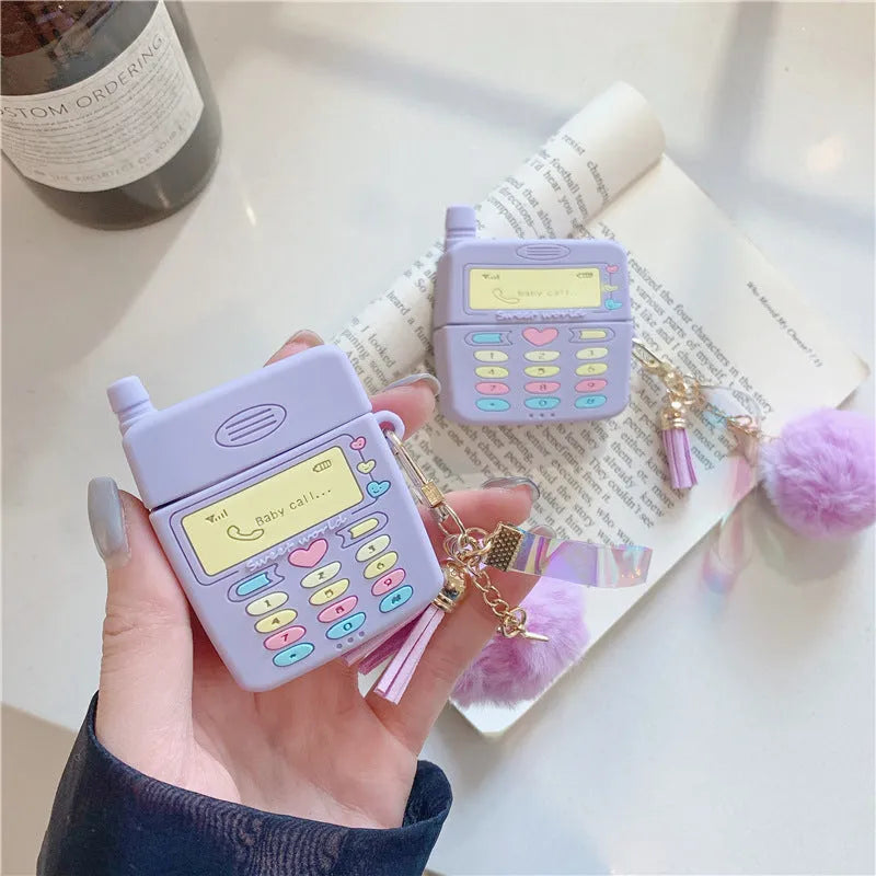 Purple silicone clamshell case for Apple AirPods Pro and AirPods 1 2 with a fur ball pendant.