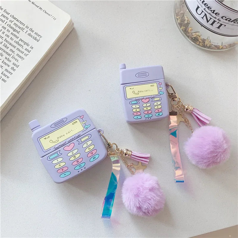Purple silicone clamshell case for Apple AirPods Pro and AirPods 1 2 with a fur ball pendant.