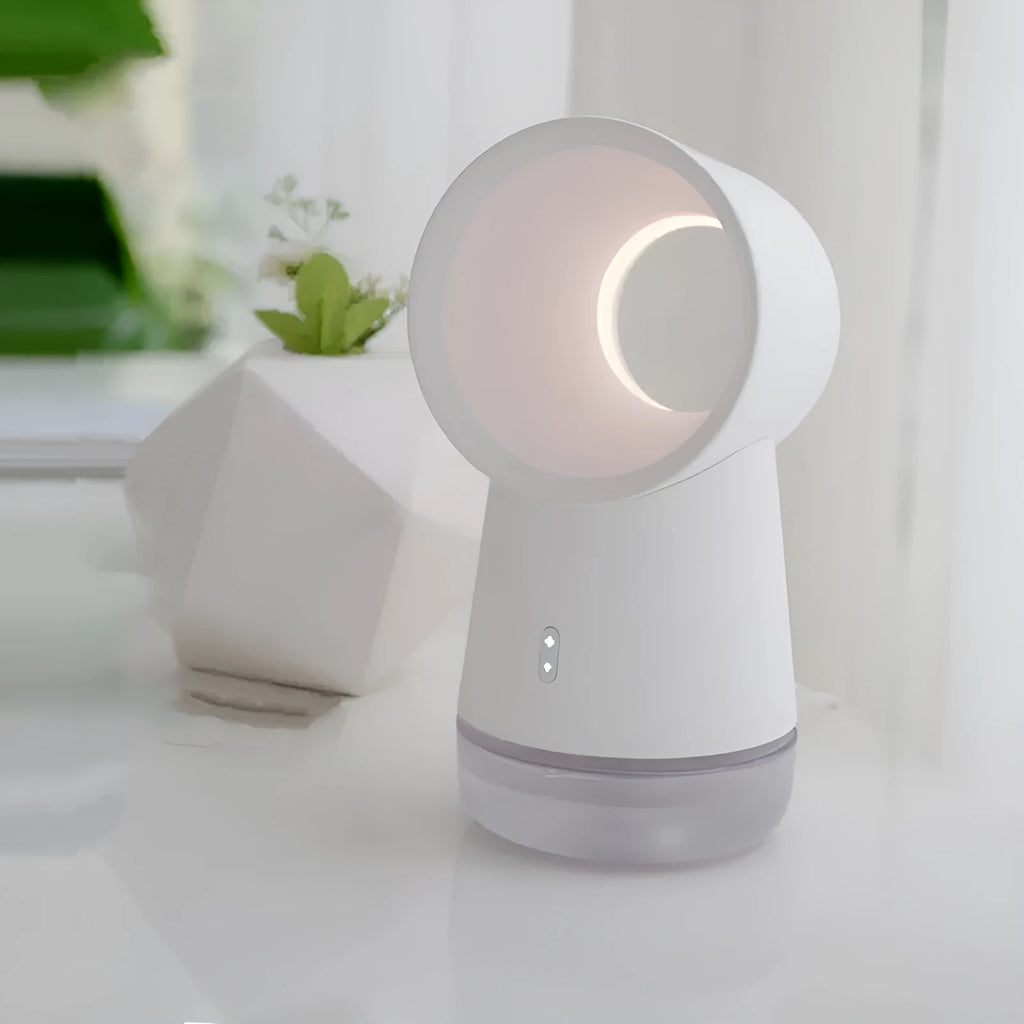 White round desktop humidifier with leafless fan vent, ultrasonic cool mist fog outlet, USB cable, and warm night light glowing