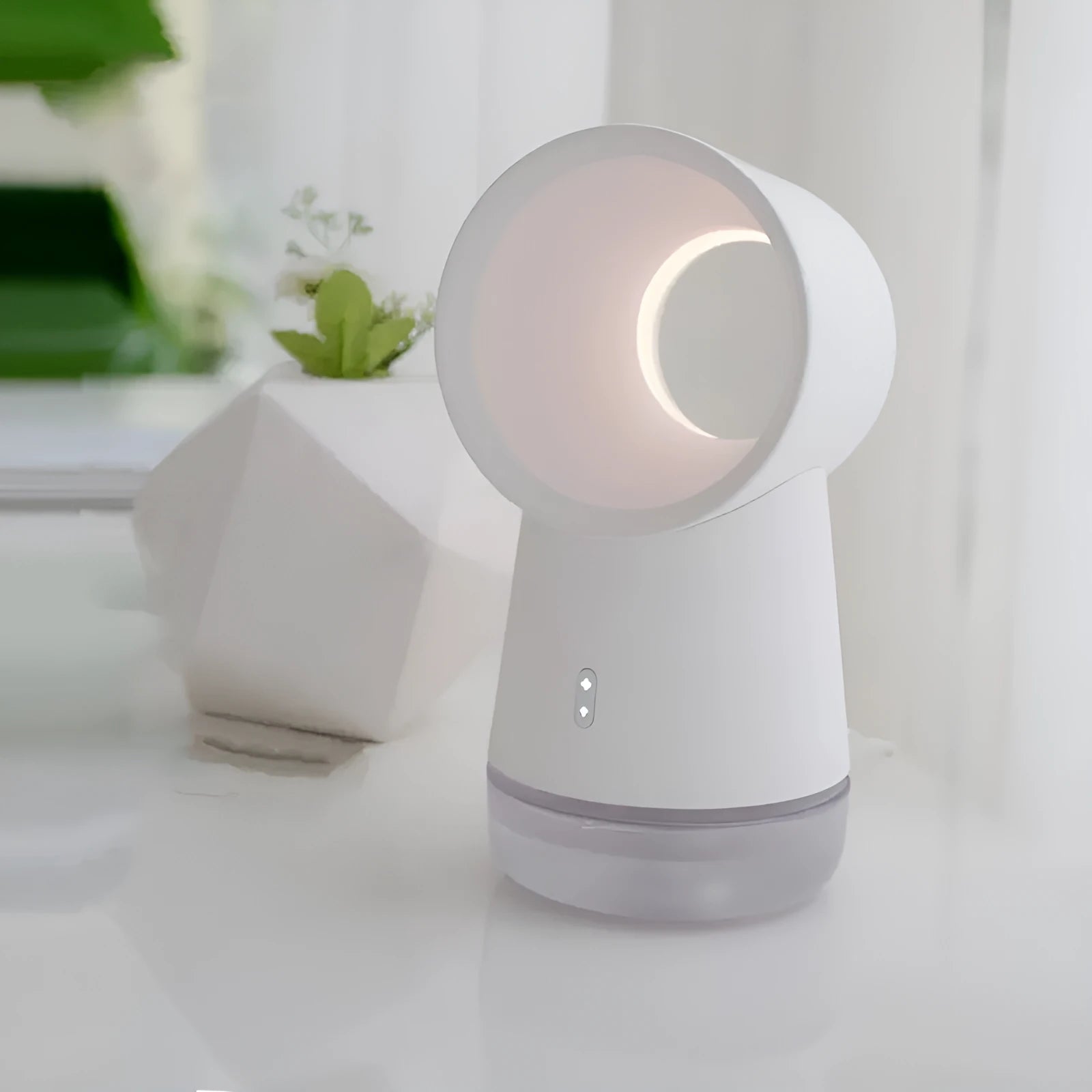 White round desktop humidifier with leafless fan vent, ultrasonic cool mist fog outlet, USB cable, and warm night light glowing