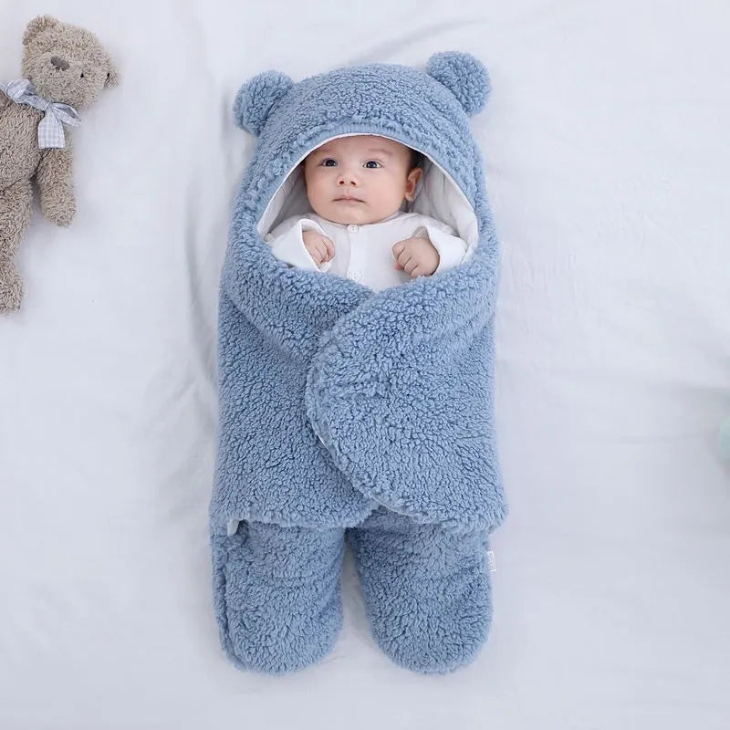 Baby quilted sleeping bag wrapper in cotton blend fabric with polyester cotton filling, shown in one of six colours