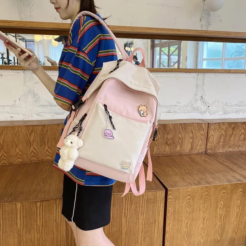 Korean style college backpack 20-35L water repellent in pink, front view