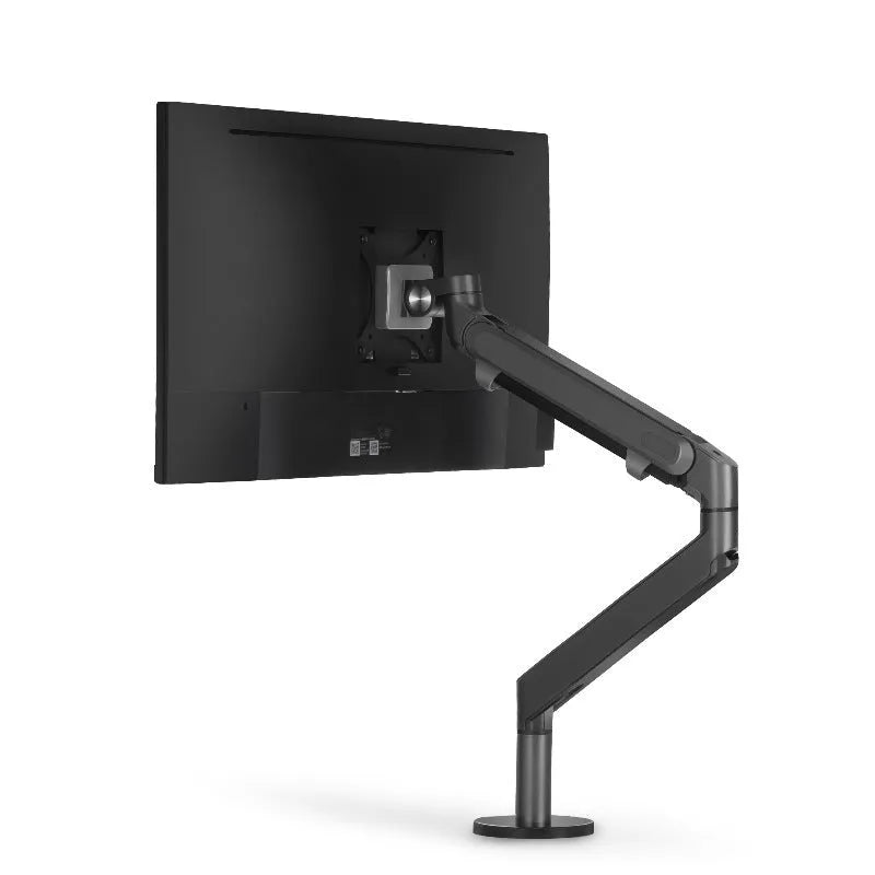 Adjustable lifting computer monitor stand in silver on a desk with a screen placed on top