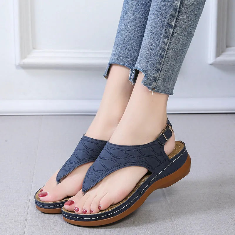 Women's casual wedge heel sandals in black with an adjustable back strap buckle.